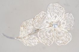 A vintage silver filigree flower brooch with roller clip clasp. Marked Sterling Germany.