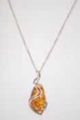 An Art Nouveau style 925 silver and amber pendant necklace.