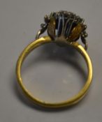 A 18ct gold Art Deco diamond and emerald ring set with three central cushion cut emeralds with