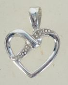 A 9ct white gold necklace pendant in the form of a heart with illusion set diamond being marked 375