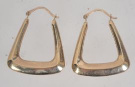 A pair of 9ct gold creole hoop earrings with lever backs. Tests 9ct gold. Marked 375.