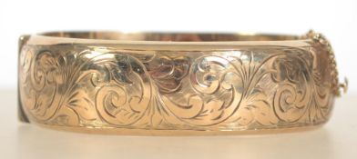 A large 9ct gold / 375 hallmarked ladies bangle complete with the safety clasp.