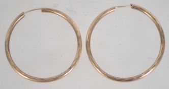 A pair of 9ct gold large hoop earrings with textured decoration. Measures diameter 3.5cms.