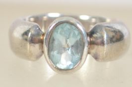 A silver 925 ladies dress ring with central bezel set pale blue topaz stone. Ring size L.5 weighs 8.