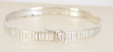 A hallmarked silver flat linked bracelet with hidden clip clasp. hallmarked London import.