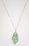 A 925 silver and jade style pendant necklace. The pendant in the form of foliates. Weight 5.8g.