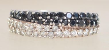 A silver 925 ladies dress ring with two adjacent channel of white CZ and blue paste stones arranged