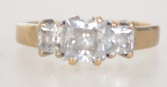 A hallmarked contemporary 9ct gold and 3 CZ stone ring. The 3 square cut stones being claw mounted.