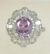 A silver 925 ladies Art Deco style dress ring set with a large oval cut amethyst stone surrounded