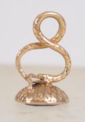 An 18ct gold fob pendant with serpent scroll bale set with a purple stone with intaglio anchor.