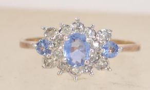 A hallmarked 9ct gold diamond and tanzanite cluster ring. Diamonds 12pts. Hallmarked Birmingham.