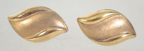 A pair of 9ct marked ladies gold earrings in the form of leaves having post backs.
