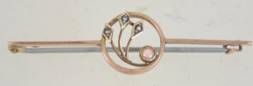 An Art Nouveau 9ct gold opal and pearl brooch having a c clasp. Marked 9ct tests 9ct gold.