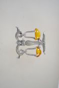 A vintage silver tone and enamel brooch in the form of a scales in flight with marcasite set stand
