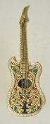 A 1960s Spanish goldtone metal brooch in the form of a guitar with a rollover catch.