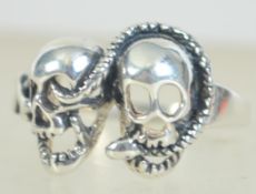A 925 silver twin skull ring with entwined snake. Marked 925. Size T.