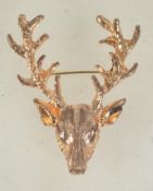 A vintage goldtone metal stags head brooch having rollover catch. Measures 5.