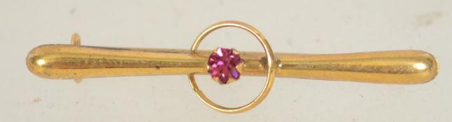 A Edwardian 9ct gold bar brooch with circle and central set stone with c clasp.