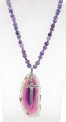 An amethyst pendant necklace with large stone agate slice pendant with dagger. Measures 20 inches.
