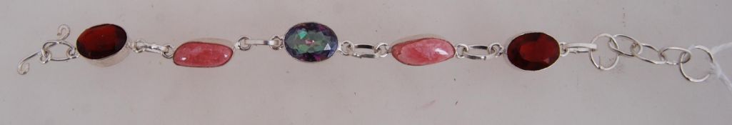 A 925 silver bracelet with faceted blue, pink and red glass stone links with toggle clasp.