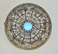 A large 1920s Czech silvered brass filigree brooch set with faux turquoise rhinestones having