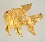 A 1960s goldtone metal and rhinestone brooch in the form of a fish with rollover catch. Measures 4.