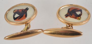 A pair of gold tone and enamel cufflinks with pictures of horses.