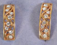 A pair of gold tone clip on earrings set with rhinestones. Measures 2.5cms.