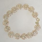 An Italian 925 silver bracelet with pierced snowflake links with lobster claw clasp. Measures 7.