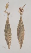 A pair of 9ct gold drop earrings in the form of leaves with post backs. Marked 9ct tests 9ct gold.