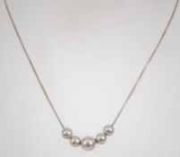 A 925 silver necklace with ball pendants. Measures 16 inches.