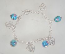 A silver bracelet hung with Art Nouveau style hearts and paper weight glass beads and toggle