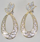 A pair of large silver and gold tone clip on earrings in the form of stylized pineapples studded