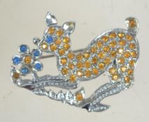 A 1950s rhinestone Bambi brooch in silvertone metal with blue and yellow rhinestones with rollover