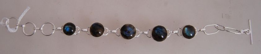 A 925 silver braclet with cabochon stone links with toggle clasp. Marked 925.