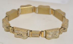 A vintage gold tone bracelet with enamelled glass metal bound links with clip clasp. Measures 7.