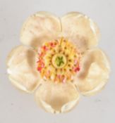 A vintage carved celluloid brooch in the form of a flower with c clasp.