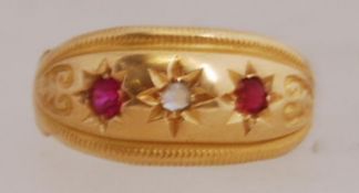 An early 20th century 18ct gold ring with rubies and diamonds in a star setting.