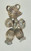 A 1960s goldtone metal and rhinestone brooch in the form of a stylised teddybear playing cymbals