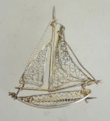 A vintage silver filigree brooch in the form of a yacht having loop catch. Marked 800 measures 4.