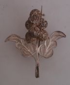 A white metal large filigree brooch with c clasp. Measures 3 inches. weight 16.5g.