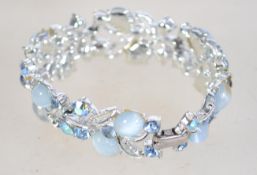 A 1950s bracelet by Listner with blue and aurora rhinestones and satin glass cabochons having