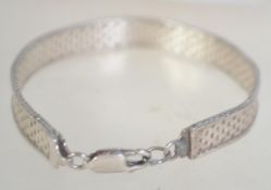 A hallmarked 925 silver flat woven chain bracelet. Import mark for London. Measures approx 7.