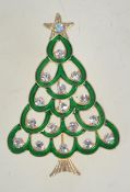 A vintage enamel and rhinestone Christmas tree brooch in gold tone metal with a rollover catch.