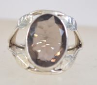 A 925 silver ring set with a central smokey quartz with split stylized leaf shoulders. Size N.5.