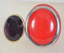 Two vintage dress rings, one with purple faceted stone and the other red bakelite with chrome ring.
