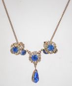 A vintage rhinestone set necklace and clip on earring suite. Measures necklace 16 inches.