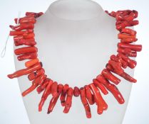A Large red coral festoon collar necklace with large spring hoop clasp. Measures approx 16 inches.