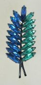 A 1960s rhinestone brooch in the form of a leaf with blue turquoise marquise rhinestones in an