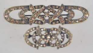 Two white metal rhinestone set brooches with roller clasps. Measures 5.5cms and 3.